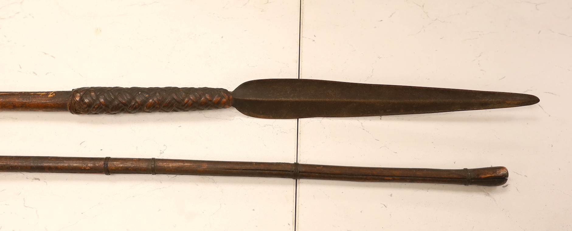 Two African throwing spears and a carved spoon with figural handle, longest spear 132cm